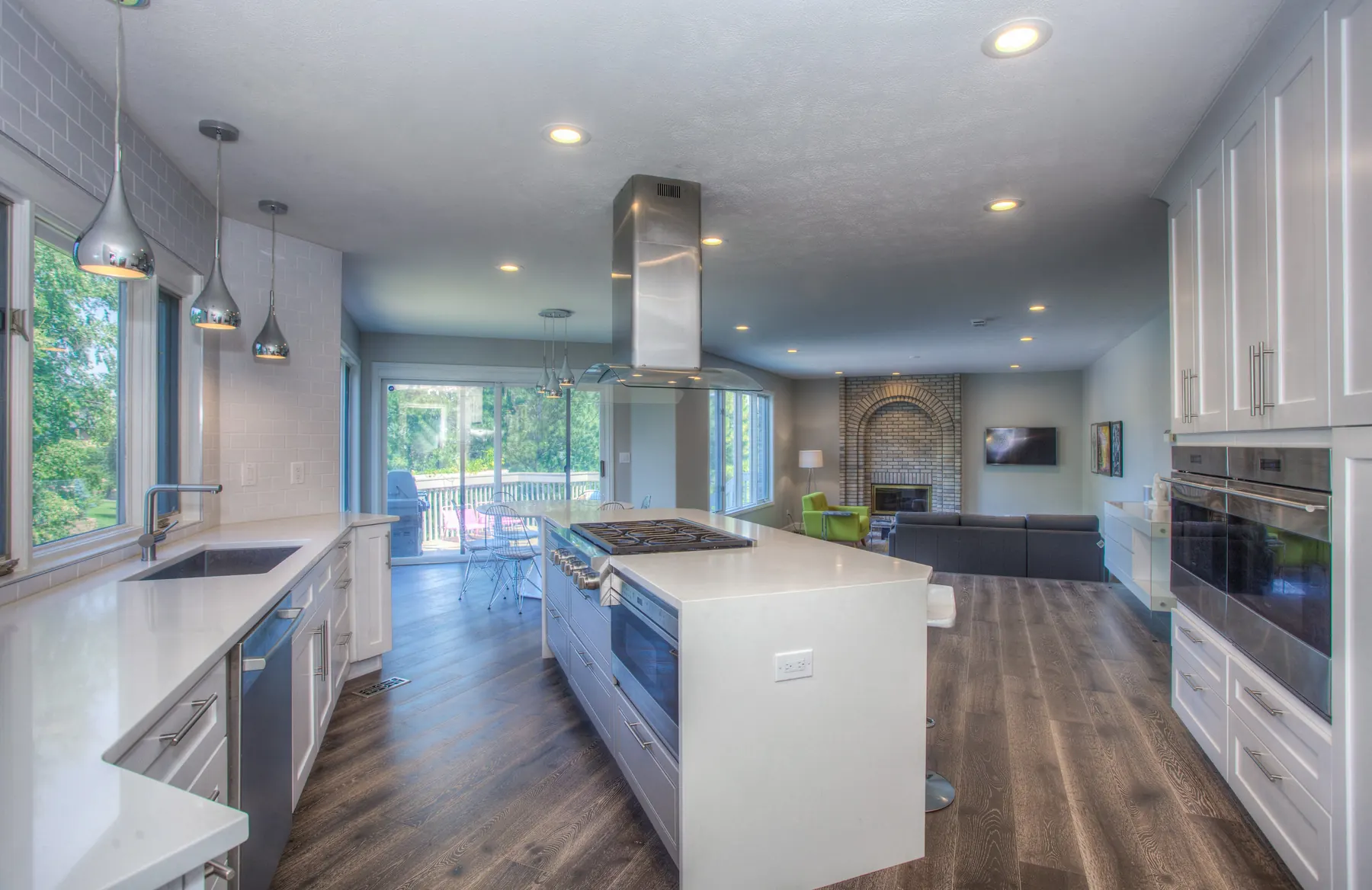 A modern kitchen with white cupboards and a quartz-look worktop